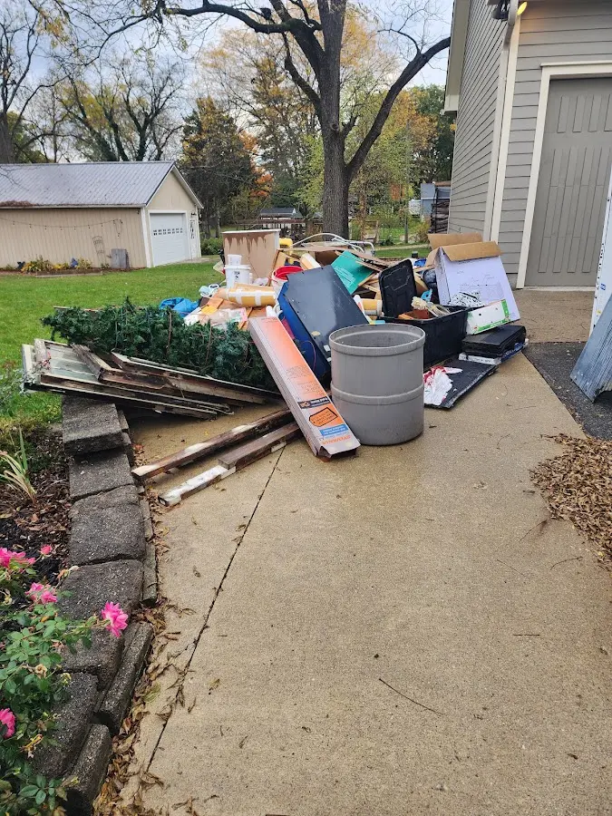 Dumpster being loaded with debris for Estate Cleanout Dumpster Rental in Moscow Mills